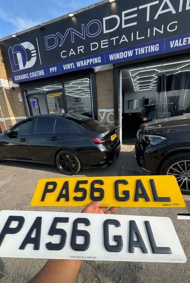 4D number plates pressed by Dyno Details Dagenham — white and yellow PA56 GAL plates held up outside the Dyno Details car detailing studio