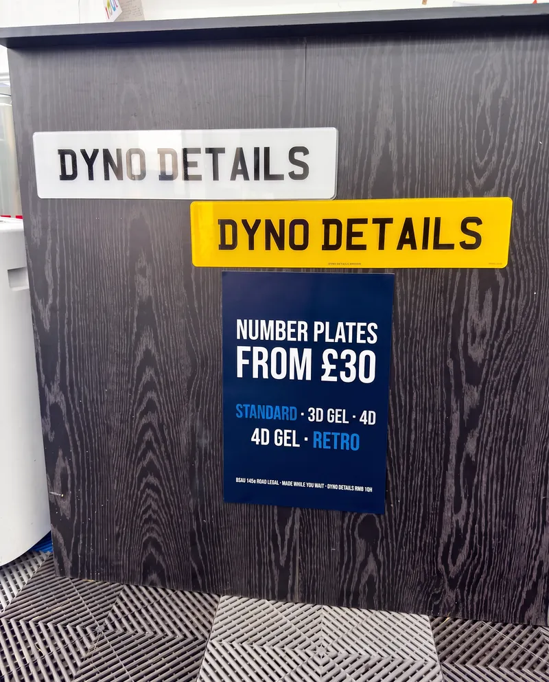Wall of finished number plate styles at the Dyno Details workshop