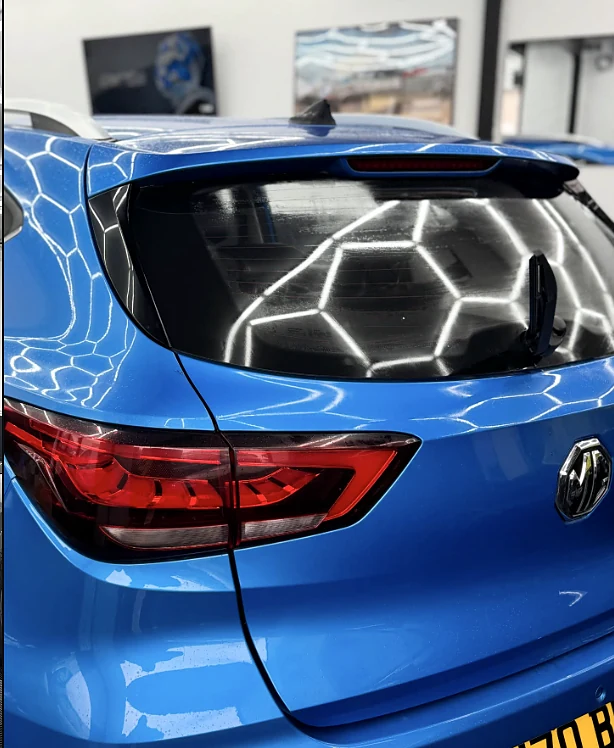 Ceramic-coated VW under hex lighting at the Dyno Details Dagenham studio